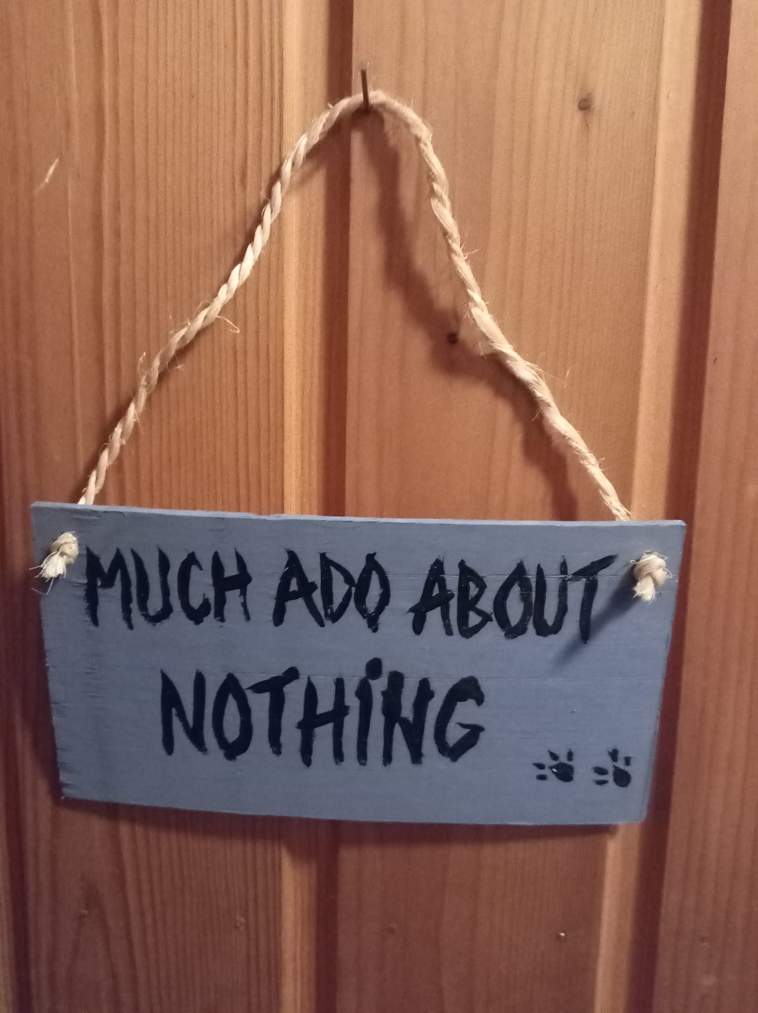 Handmade laminate sign with Much Ado About Nothing text and rope hanger