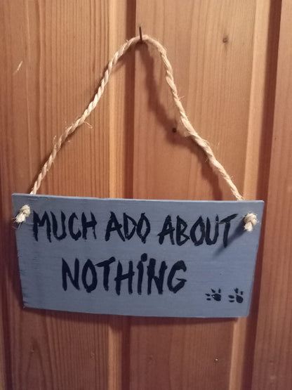 Handmade laminate sign with Much Ado About Nothing text and rope hanger